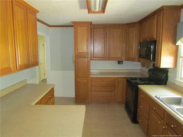 310 N Farmers Rd, Fayetteville, NC 28311 - kitchen with black appliances, light countertops, and brown cabinets