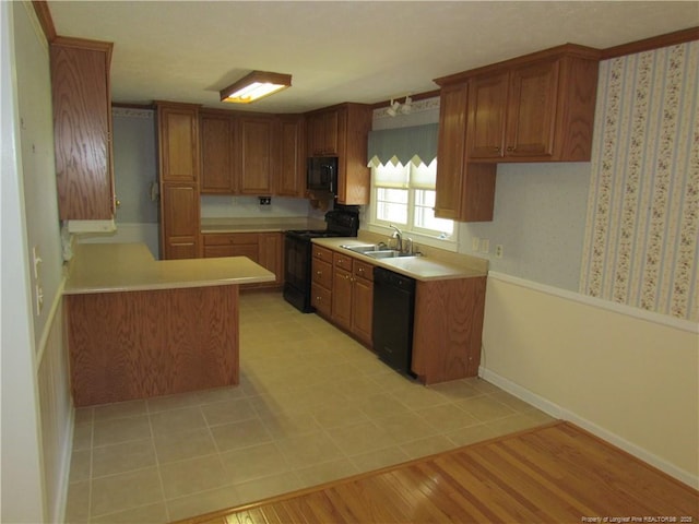 310 N Farmers Rd, Fayetteville, NC 28311 - kitchen with black appliances, brown cabinets, and light countertops