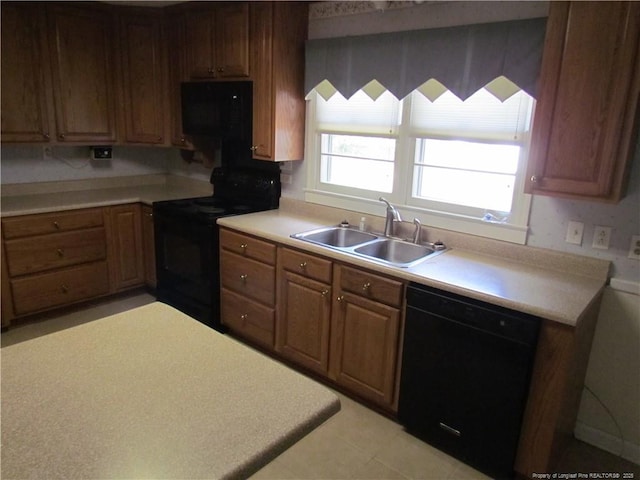 310 N Farmers Rd, Fayetteville, NC 28311 - kitchen with black appliances, light countertops, and brown cabinets