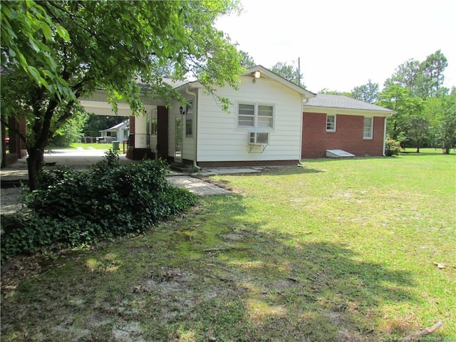 310 N Farmers Rd, Fayetteville, NC 28311 - rear view of house featuring a lawn, brick siding, and cooling unit