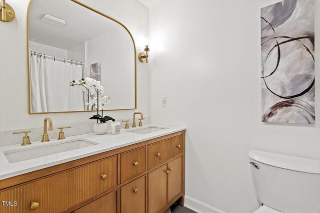 6311 Brandywine Rd, Raleigh, NC 27607 - bathroom with double vanity and toilet
