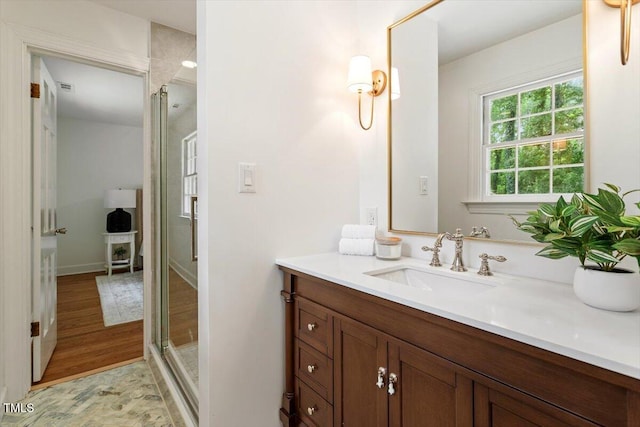6311 Brandywine Rd, Raleigh, NC 27607 - bathroom featuring vanity, a shower stall, and wood finished floors