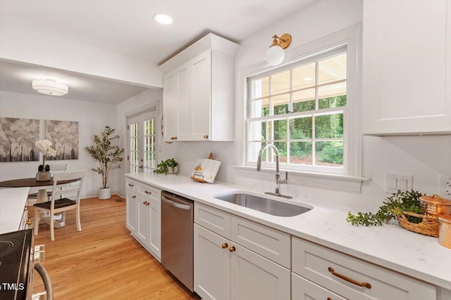 6311 Brandywine Rd, Raleigh, NC 27607 - kitchen with dishwasher, electric stove, white cabinetry, light wood-style flooring, and light stone countertops