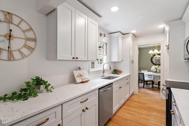 6311 Brandywine Rd, Raleigh, NC 27607 - kitchen featuring stainless steel appliances, white cabinetry, light wood-type flooring, light stone counters, and recessed lighting
