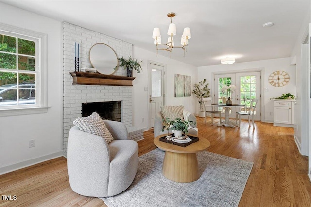 6311 Brandywine Rd, Raleigh, NC 27607 - living room with healthy amount of natural light, wood finished floors, and a fireplace