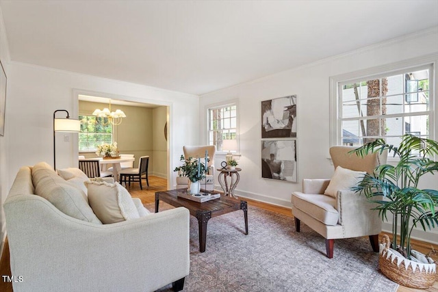 6311 Brandywine Rd, Raleigh, NC 27607 - living area featuring a chandelier, ornamental molding, and wood finished floors