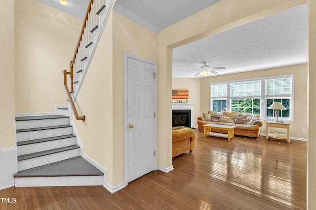 2114 Baycourt Trl, Hillsborough, NC 27278 - staircase with hardwood / wood-style flooring, ceiling fan, and a fireplace