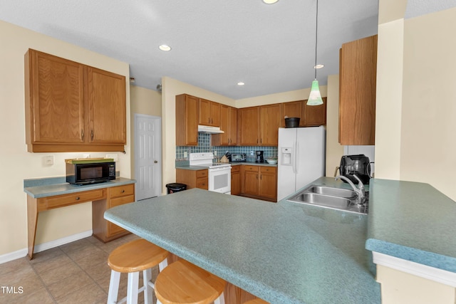 2114 Baycourt Trl, Hillsborough, NC 27278 - kitchen with white appliances, a peninsula, under cabinet range hood, a kitchen bar, and recessed lighting