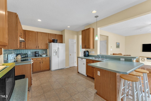 2114 Baycourt Trl, Hillsborough, NC 27278 - kitchen with white appliances, under cabinet range hood, a peninsula, backsplash, and a kitchen breakfast bar