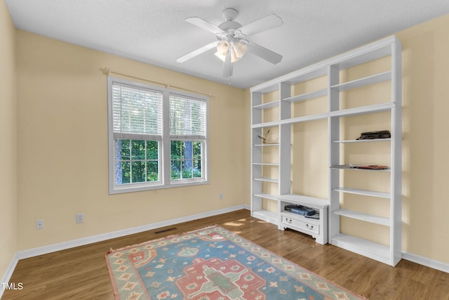 2114 Baycourt Trl, Hillsborough, NC 27278 - unfurnished room with wood finished floors, ceiling fan, and a textured ceiling