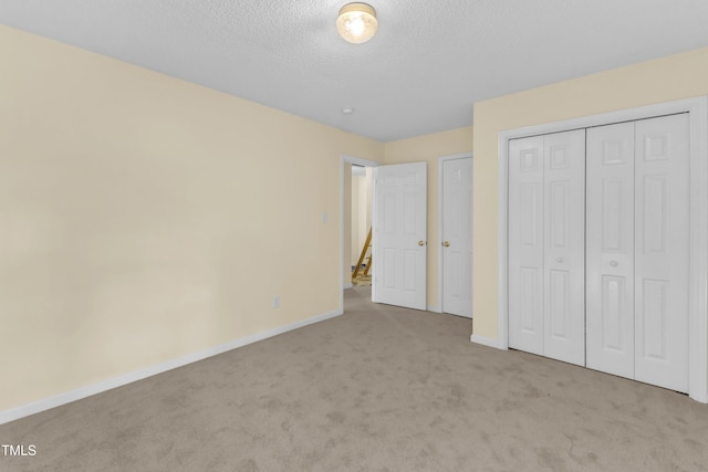 2114 Baycourt Trl, Hillsborough, NC 27278 - unfurnished bedroom featuring carpet, a textured ceiling, and a closet