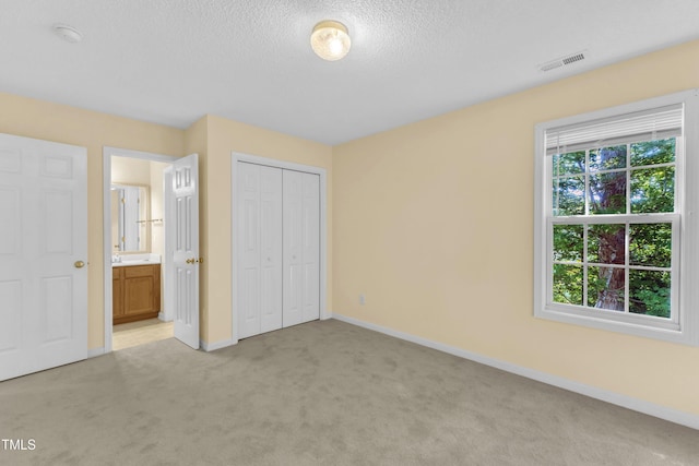 2114 Baycourt Trl, Hillsborough, NC 27278 - unfurnished bedroom with light carpet, a textured ceiling, a closet, and ensuite bathroom