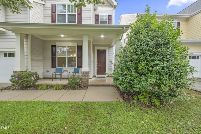 1204 Chapanoke Rd, Raleigh, NC 27603 - property entrance with covered porch and a garage