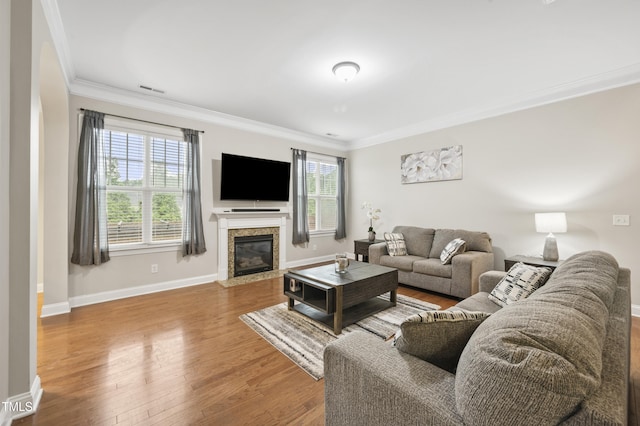 1204 Chapanoke Rd, Raleigh, NC 27603 - living room featuring ornamental molding, wood finished floors, and a glass covered fireplace
