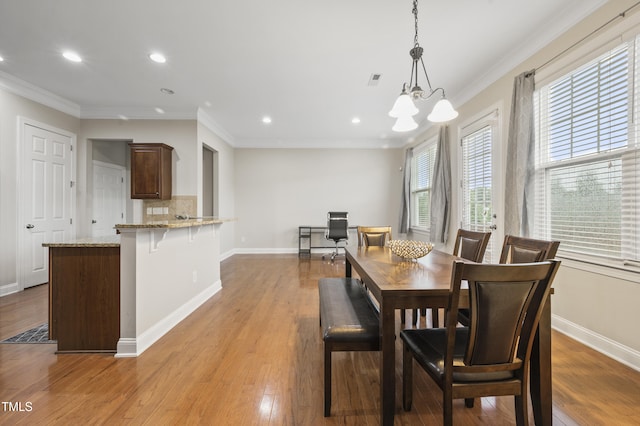 1204 Chapanoke Rd, Raleigh, NC 27603 - dining area with ornamental molding, a chandelier, recessed lighting, and wood finished floors