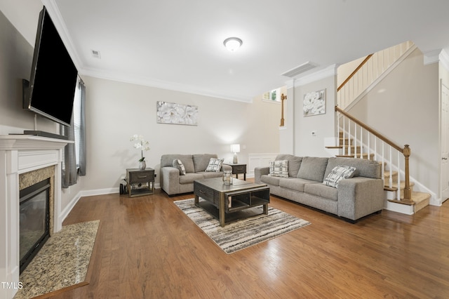 1204 Chapanoke Rd, Raleigh, NC 27603 - living room with stairs, crown molding, wood finished floors, and a high end fireplace