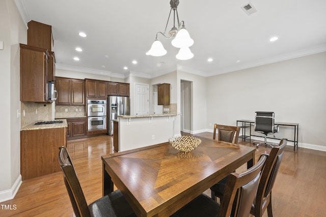 1204 Chapanoke Rd, Raleigh, NC 27603 - dining space featuring recessed lighting, light wood-style floors, ornamental molding, and a chandelier