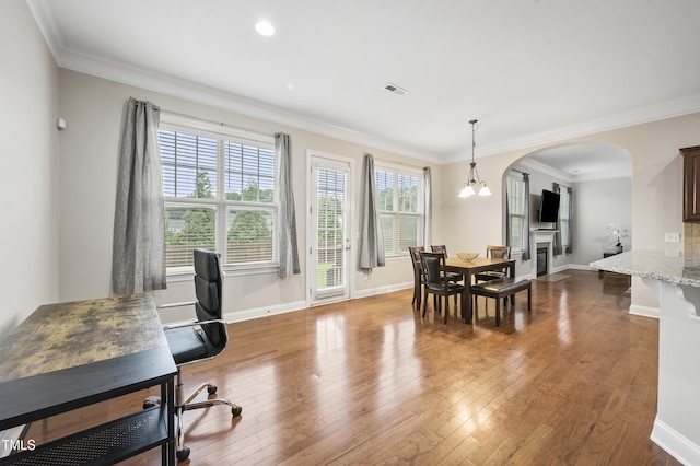 1204 Chapanoke Rd, Raleigh, NC 27603 - dining area featuring arched walkways, hardwood / wood-style floors, and ornamental molding