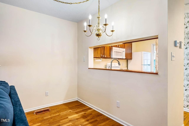 7 Georgetown Ct, Durham, NC 27705 - unfurnished dining area featuring a chandelier and wood finished floors