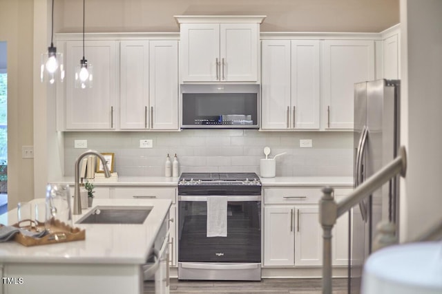 1004 Citadel Ave, Durham, NC 27713 - kitchen with appliances with stainless steel finishes, light countertops, white cabinets, and tasteful backsplash