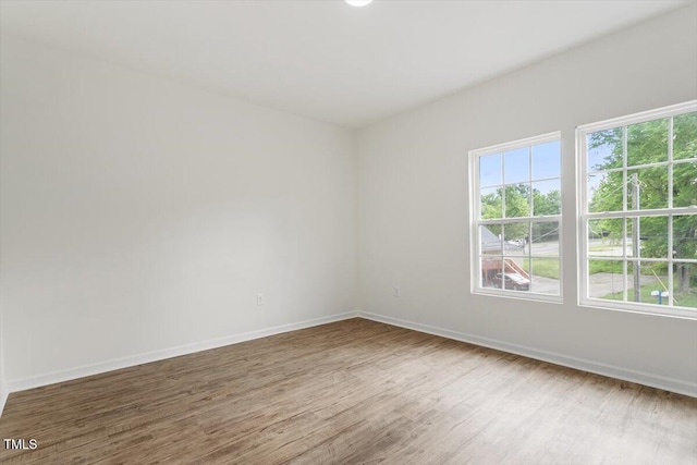 1408 S St, Durham, NC 27707 - unfurnished room featuring healthy amount of natural light and wood finished floors