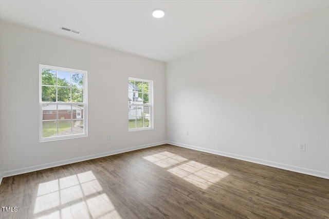 1408 S St, Durham, NC 27707 - empty room featuring dark wood finished floors and baseboards