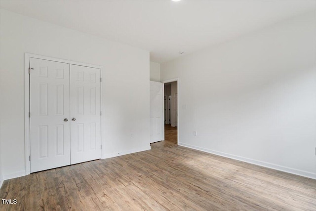 1408 S St, Durham, NC 27707 - unfurnished bedroom featuring wood finished floors and a closet