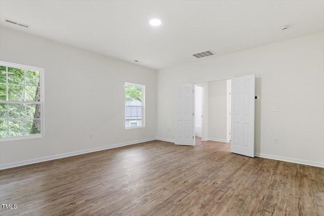 1408 S St, Durham, NC 27707 - unfurnished room featuring plenty of natural light, wood finished floors, and a smoke detector
