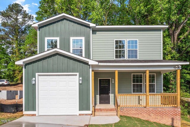 1408 S St, Durham, NC 27707 - view of front of property featuring covered porch, board and batten siding, and concrete driveway
