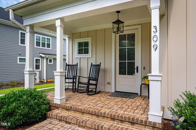 309 N Mason St, Apex, NC 27502 - view of exterior entry featuring covered porch and board and batten siding