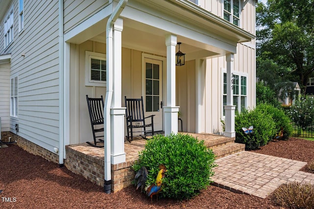 309 N Mason St, Apex, NC 27502 - view of exterior entry featuring board and batten siding and a porch