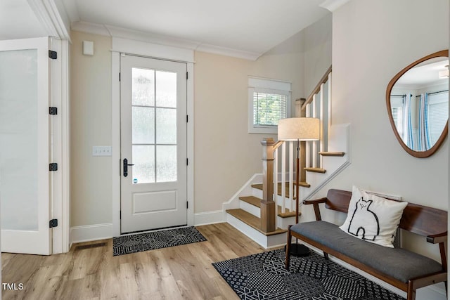 309 N Mason St, Apex, NC 27502 - entrance foyer with ornamental molding, stairway, and light wood-style floors