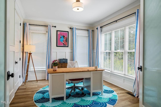 309 N Mason St, Apex, NC 27502 - home office with light wood-type flooring, ornamental molding, a decorative wall, and wainscoting
