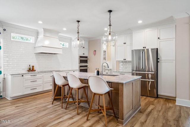 309 N Mason St, Apex, NC 27502 - kitchen featuring stainless steel appliances, custom range hood, tasteful backsplash, white cabinets, and recessed lighting