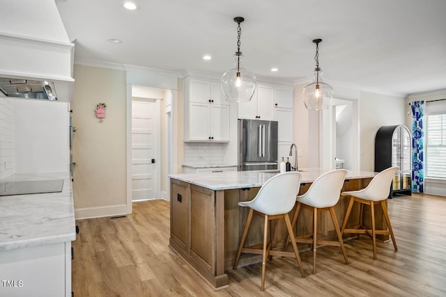 309 N Mason St, Apex, NC 27502 - kitchen with high quality fridge, custom range hood, crown molding, light wood finished floors, and white cabinetry