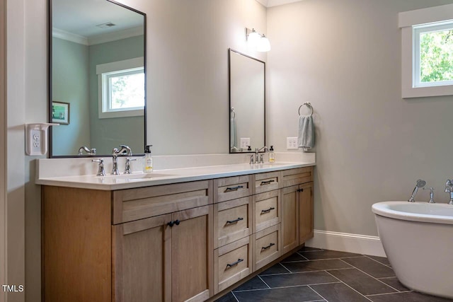 309 N Mason St, Apex, NC 27502 - bathroom featuring crown molding, double vanity, and a freestanding bath