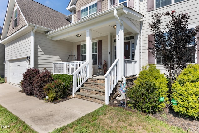 90 E Calvert Ct, Clayton, NC 27527 - view of front of property featuring covered porch, roof with shingles, and a garage