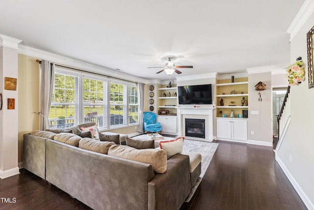90 E Calvert Ct, Clayton, NC 27527 - living room featuring a ceiling fan, dark wood-style floors, a fireplace with flush hearth, crown molding, and stairs