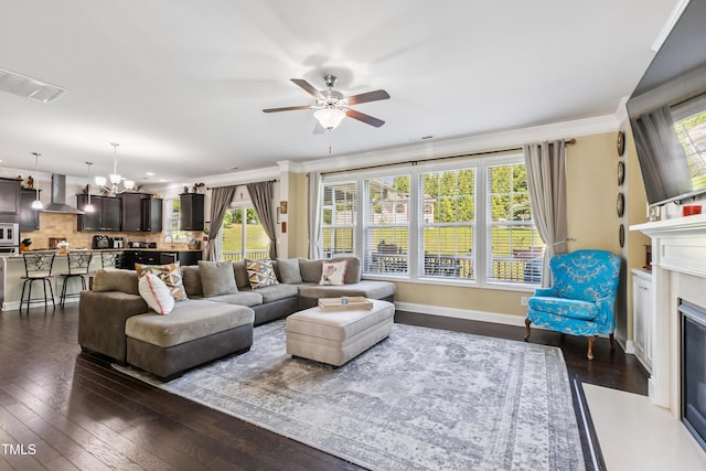 90 E Calvert Ct, Clayton, NC 27527 - living area featuring a chandelier, dark wood finished floors, a ceiling fan, a glass covered fireplace, and crown molding