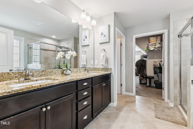 90 E Calvert Ct, Clayton, NC 27527 - bathroom featuring double vanity, a shower stall, tile patterned floors, and a walk in closet