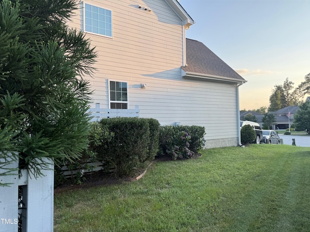 90 E Calvert Ct, Clayton, NC 27527 - view of property exterior with a lawn and a shingled roof