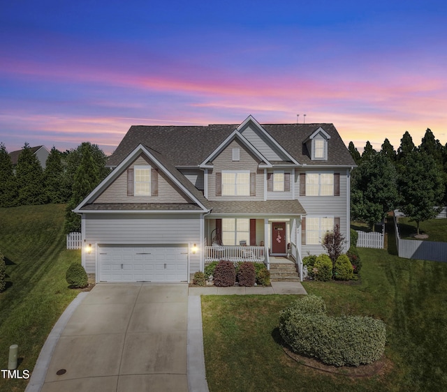 90 E Calvert Ct, Clayton, NC 27527 - view of front of house featuring covered porch, driveway, roof with shingles, and a garage
