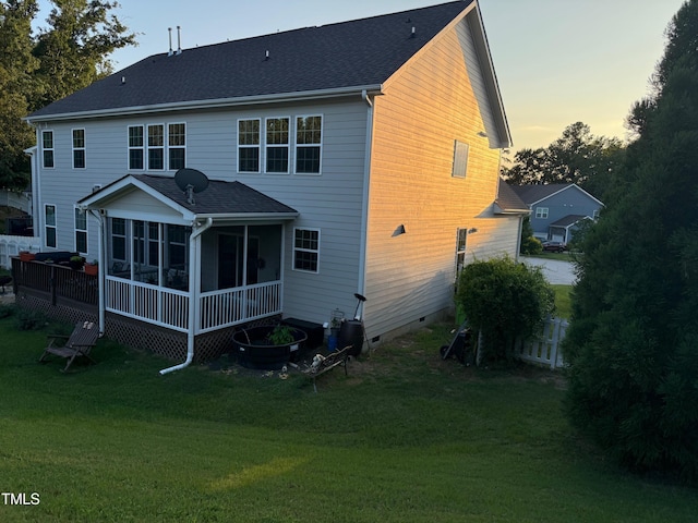 90 E Calvert Ct, Clayton, NC 27527 - back of property at dusk with a sunroom, crawl space, and a yard