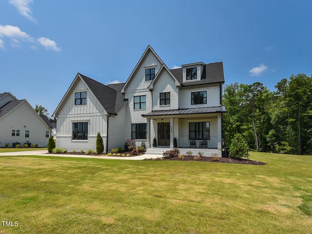 3666 Jordan Estates Way, New Hill, NC 27562 - modern farmhouse style home with board and batten siding, covered porch, a front lawn, a standing seam roof, and a metal roof