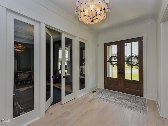 3666 Jordan Estates Way, New Hill, NC 27562 - entryway featuring french doors, a chandelier, and light wood-style flooring