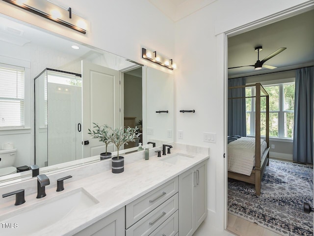 3666 Jordan Estates Way, New Hill, NC 27562 - ensuite bathroom with double vanity, a shower stall, ceiling fan, and wood finished floors