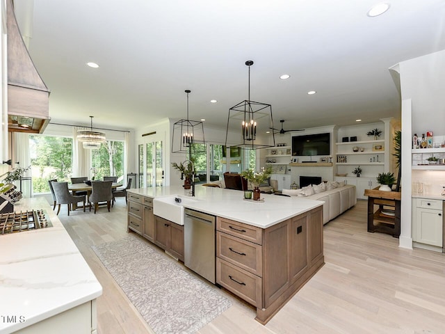 3666 Jordan Estates Way, New Hill, NC 27562 - kitchen featuring stainless steel appliances, custom range hood, light wood finished floors, a large island with sink, and recessed lighting