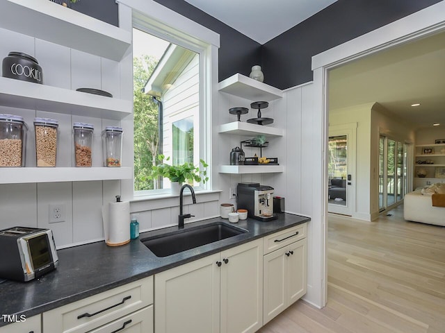 3666 Jordan Estates Way, New Hill, NC 27562 - kitchen featuring open shelves, dark countertops, light wood-type flooring, and white cabinetry