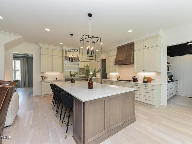 3666 Jordan Estates Way, New Hill, NC 27562 - kitchen with custom range hood, a breakfast bar area, light wood-style floors, a spacious island, and recessed lighting