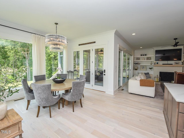 3666 Jordan Estates Way, New Hill, NC 27562 - dining space featuring a chandelier, plenty of natural light, light wood-type flooring, a fireplace, and recessed lighting